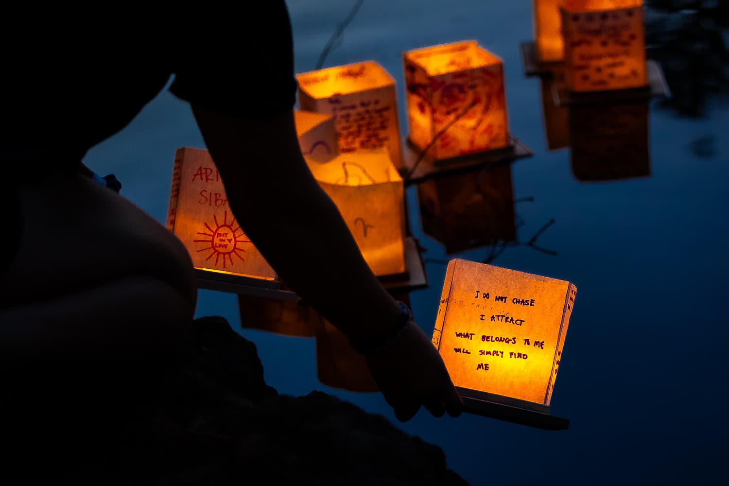Illuminated lantern reflected in water